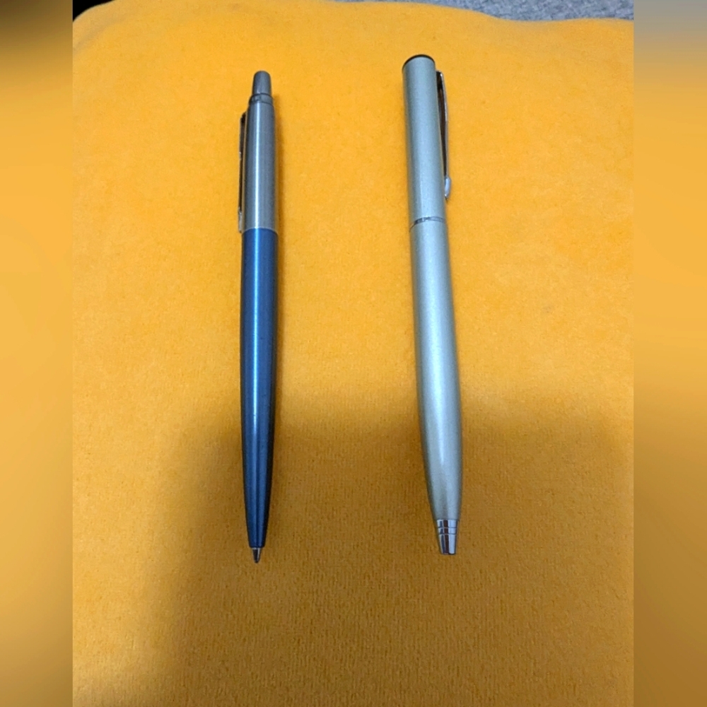 Blue and Silver Ballpoint Pens. The Blue Pen Is A Parker. The Silver: Unbranded.